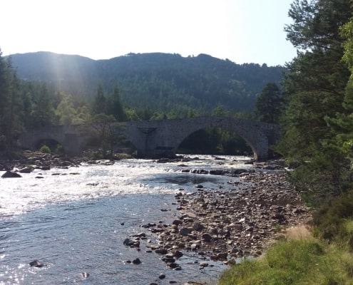a Scottish salmon fishing river in mid summer on a sunny day with low water levels